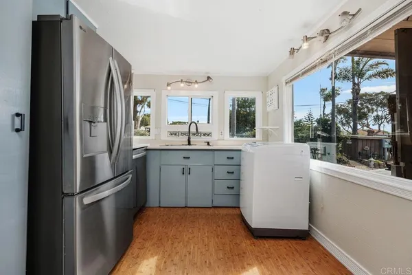 a kitchen with stainless steel appliances granite countertop a refrigerator and a sink