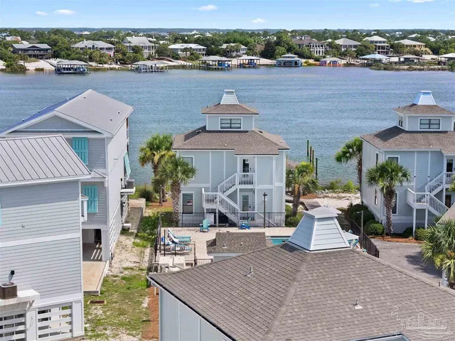 an aerial view of a house with outdoor space and lake view