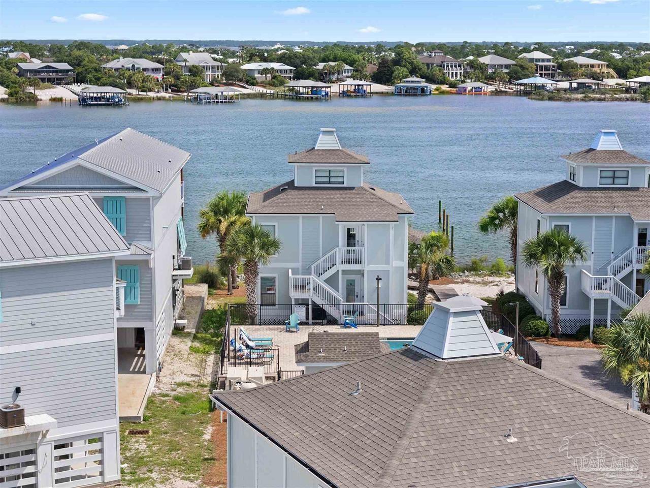 an aerial view of a house with outdoor space and lake view