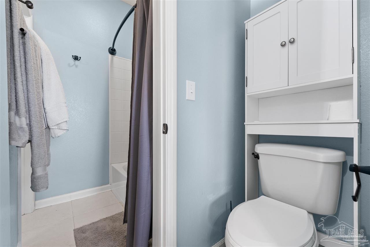 16590 Perdido Key Drive, Unit 6B Pensacola, FL 32507 - Photo 11 of 25 a white toilet sitting next to a bath tub