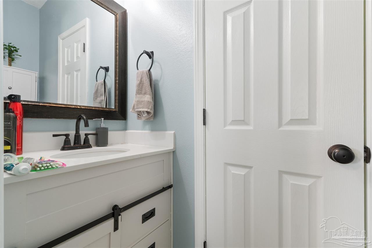 16590 Perdido Key Drive, Unit 6B Pensacola, FL 32507 - Photo 12 of 25 a bathroom with a sink vanity and a mirror