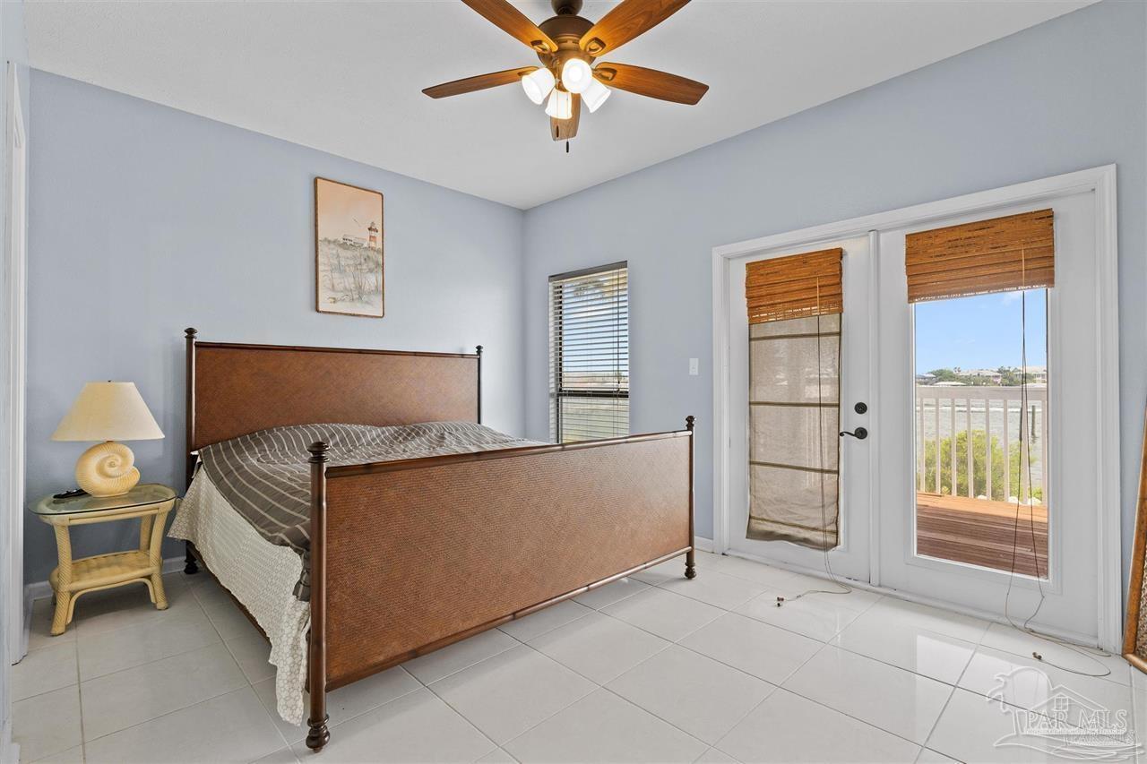 16590 Perdido Key Drive, Unit 6B Pensacola, FL 32507 - Photo 14 of 25 a bedroom with a bed and a chandelier