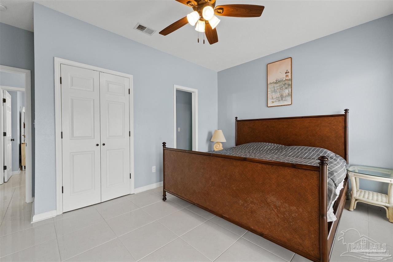 16590 Perdido Key Drive, Unit 6B Pensacola, FL 32507 - Photo 15 of 25 a bedroom with a bed and a ceiling fan