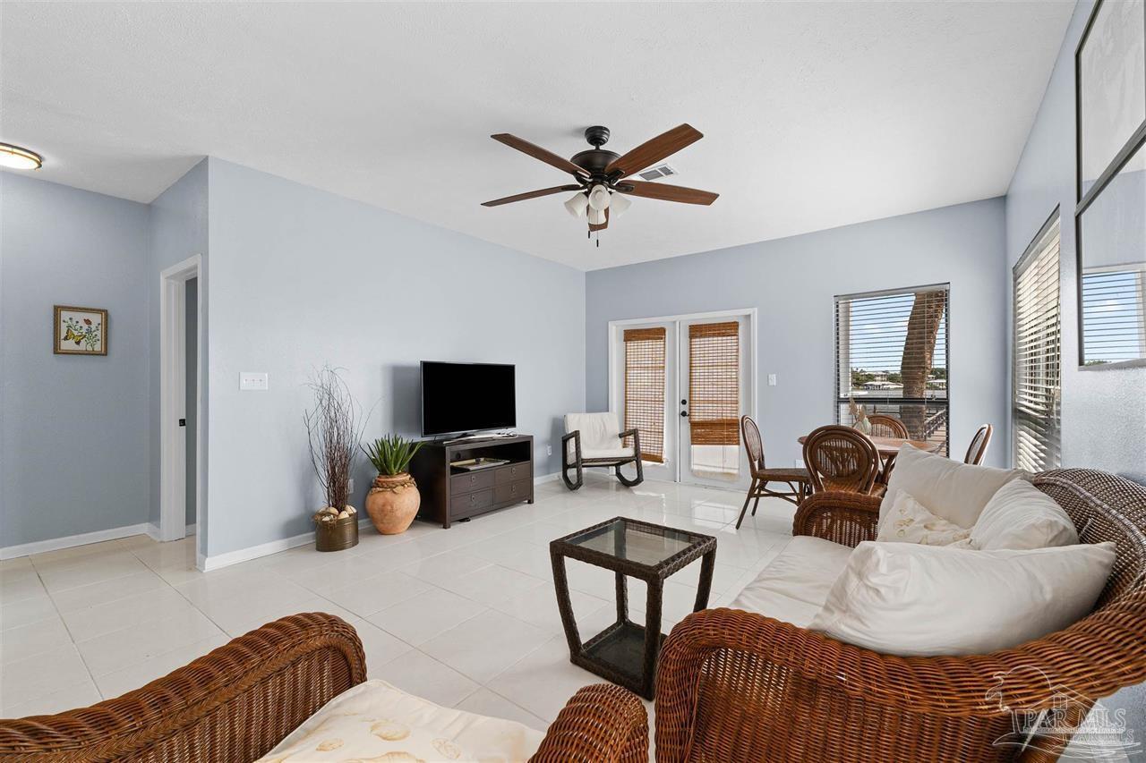 16590 Perdido Key Drive, Unit 6B Pensacola, FL 32507 - Photo 18 of 25 a living room with furniture and a flat screen tv