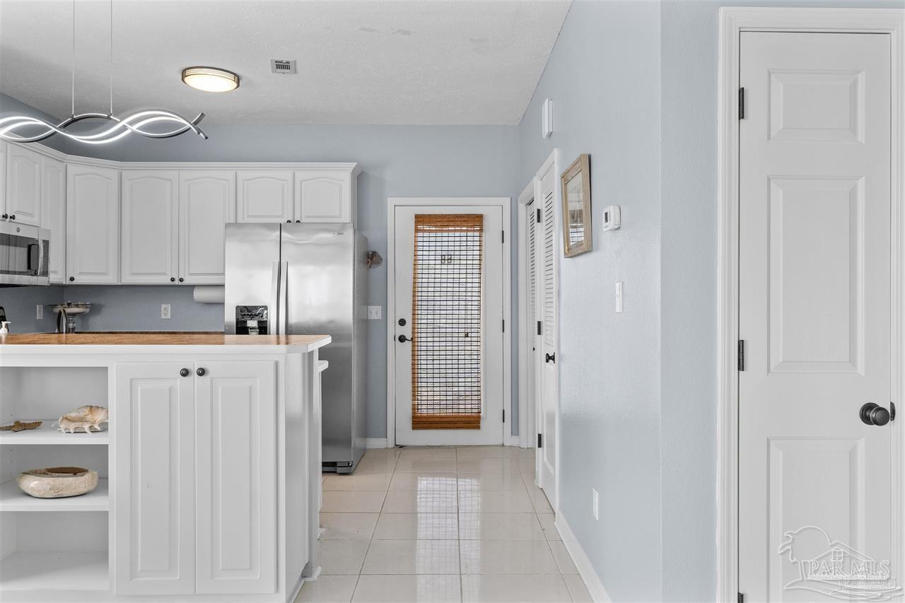 16590 Perdido Key Drive, Unit 6B Pensacola, FL 32507 - Photo 20 of 25 a bathroom with a granite countertop sink a toilet and a shower