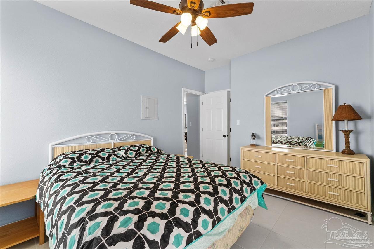 16590 Perdido Key Drive, Unit 6B Pensacola, FL 32507 - Photo 22 of 25 a bedroom with a bed and a dresser