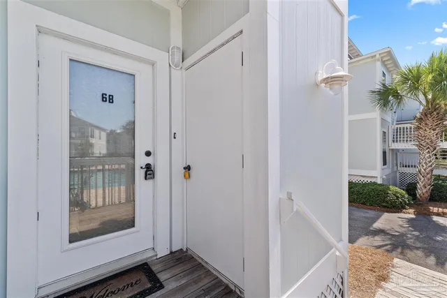 a view of a hallway with wooden floor and a living room