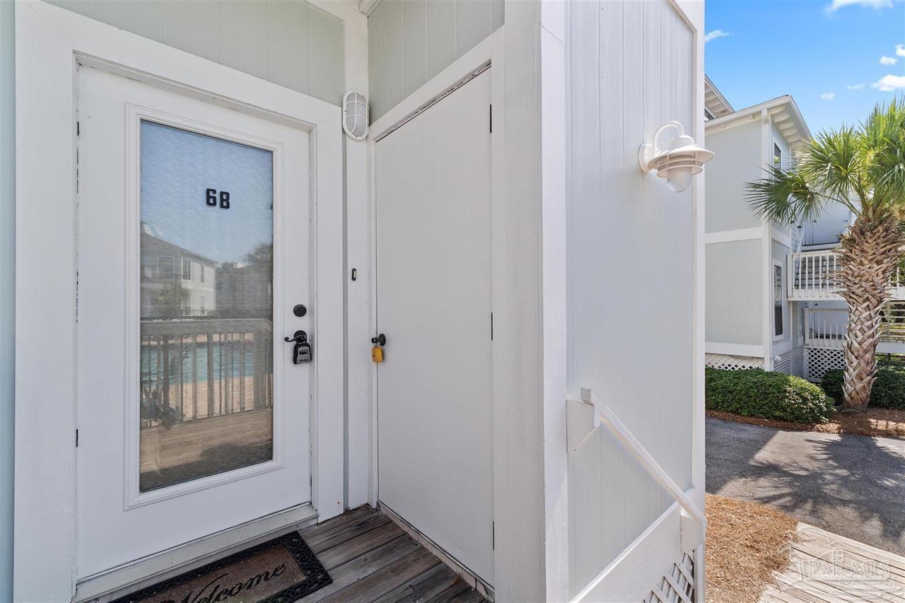 16590 Perdido Key Drive, Unit 6B Pensacola, FL 32507 - Photo 8 of 25 a view of a hallway with wooden floor and a living room