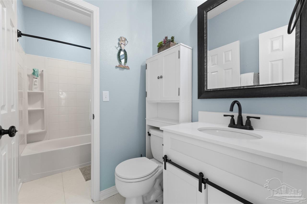16590 Perdido Key Drive, Unit 6B Pensacola, FL 32507 - Photo 9 of 25 a bathroom with a sink toilet and shower