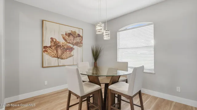 a view of a dining room with furniture and wooden floor