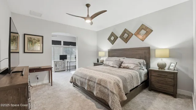 a bedroom with bed and a night stand