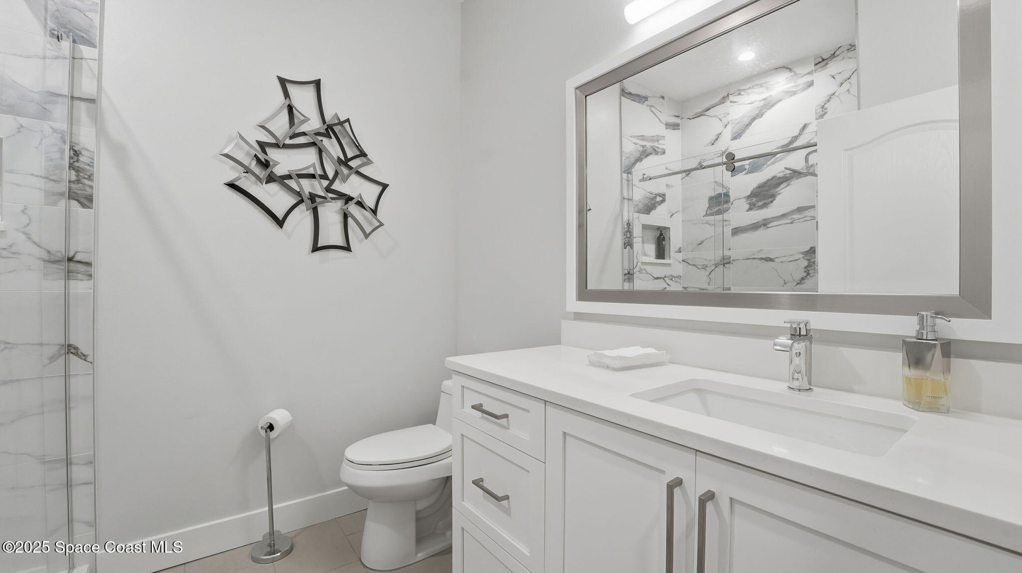 4810 Bren Court Rockledge, FL 32955 - Photo 27 of 43 a bathroom with a granite countertop sink a toilet and a mirror
