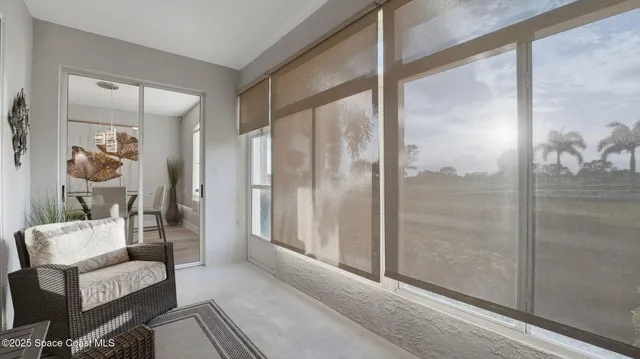 a living room with furniture and a glass door shower