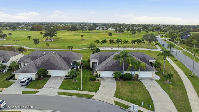 an aerial view of a house with outdoor space lake view and a view