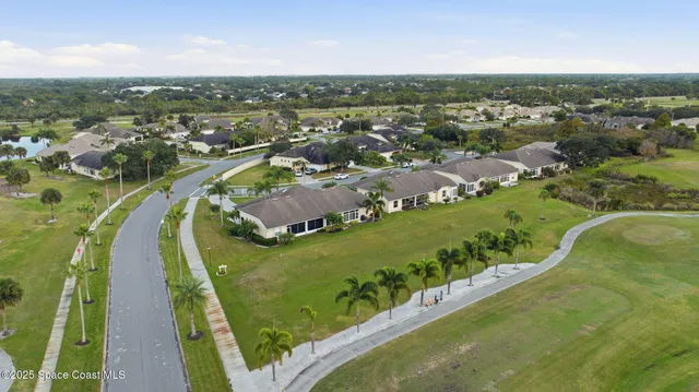 an aerial view of a residential houses with outdoor space and river