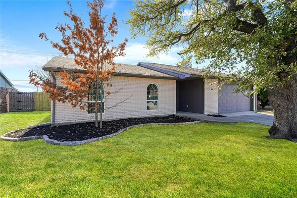 a front view of house with yard and trees