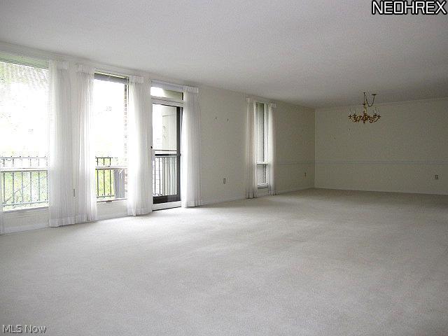 2375 Covington Road, Unit 411 Akron, OH 44313 - Photo 3 of 9 Large Living Room with wall of windows and dining room at the far end