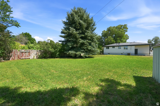 546 West 200 South Payson, UT 84651 - Photo 33 of 45 Expansive green lawn with mature trees and a wooden fence