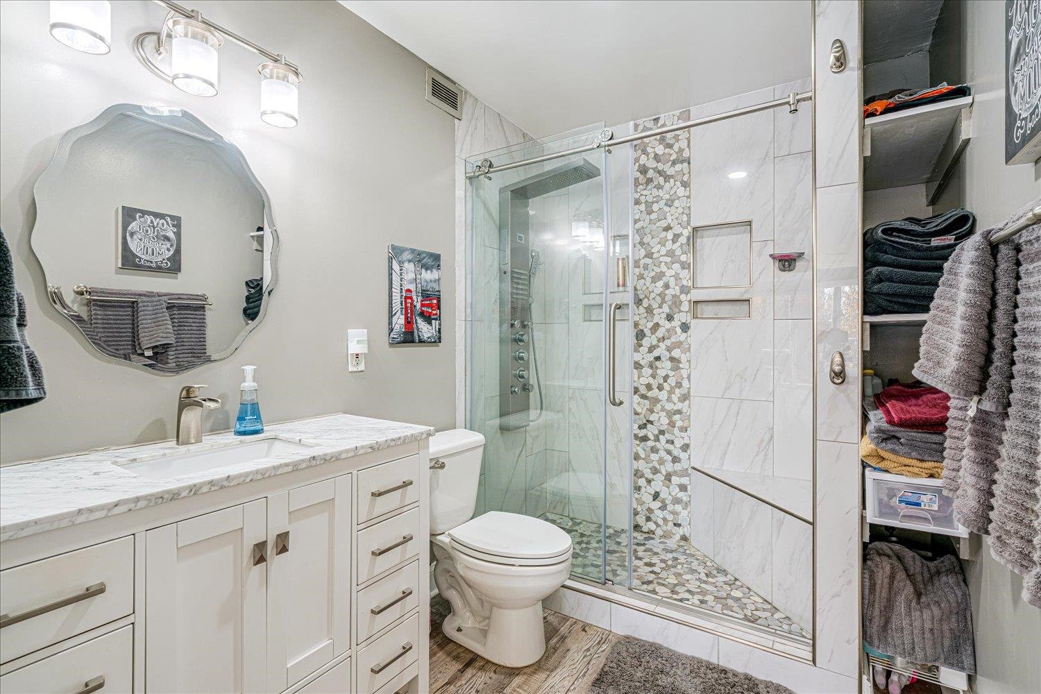 655 Riverside Drive, Unit 202 Memphis, TN 38103 - Photo 24 of 37 a bathroom with a granite countertop shower sink vanity mirror and toilet