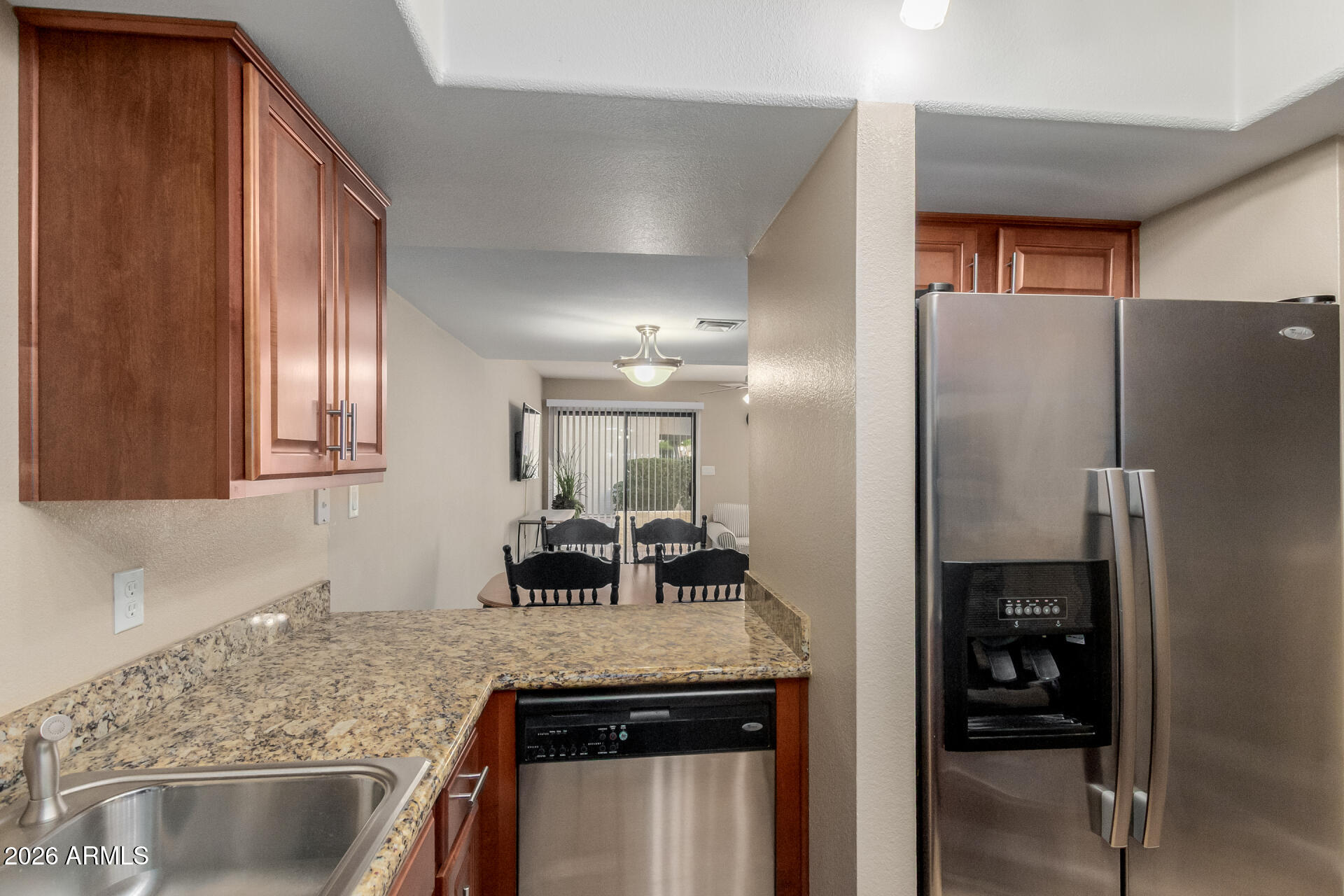 885 North Granite Reef Road, Unit 82 Scottsdale, AZ 85257 - Photo 11 of 32 a kitchen with stainless steel appliances granite countertop a refrigerator and a sink