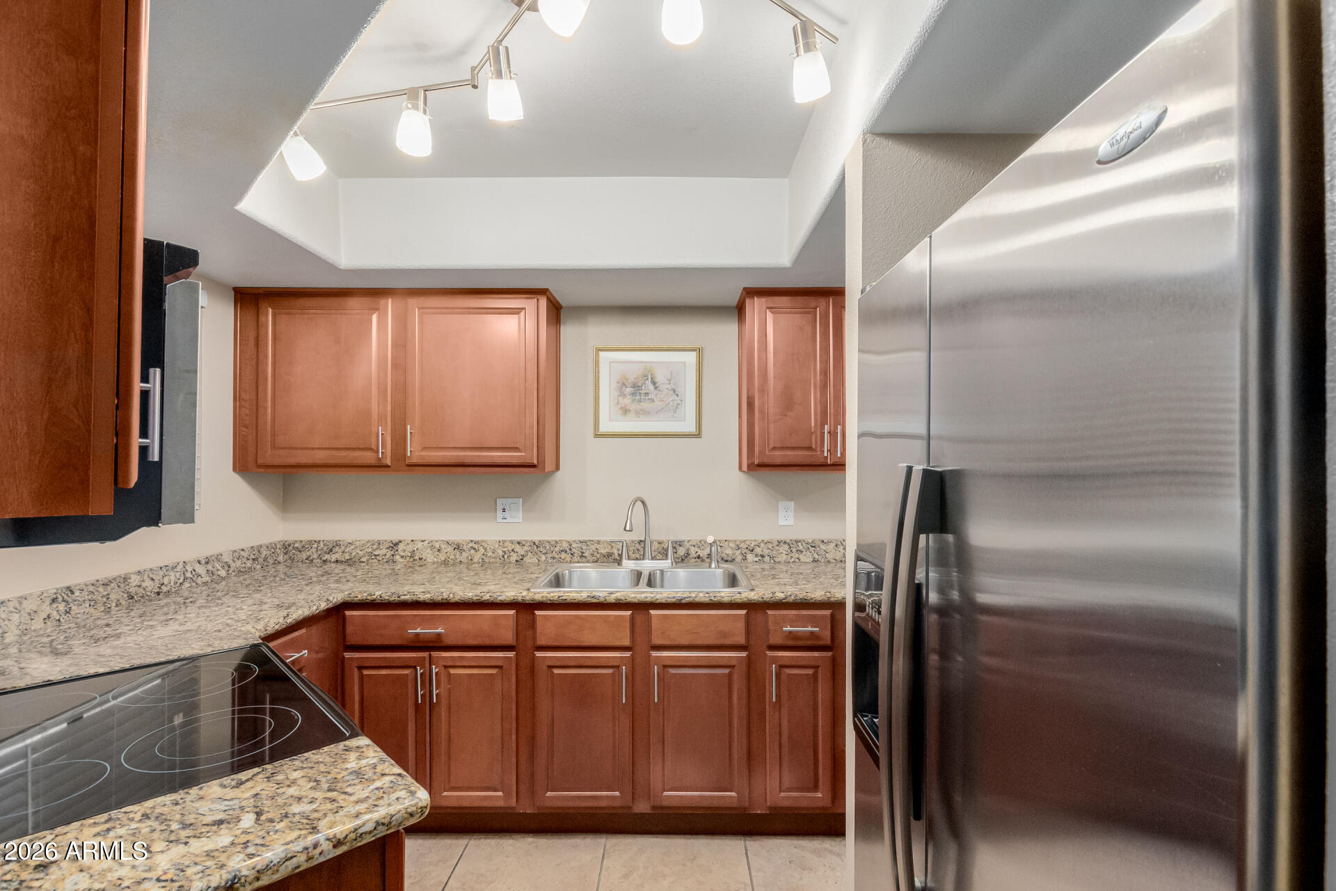 885 North Granite Reef Road, Unit 82 Scottsdale, AZ 85257 - Photo 9 of 32 a kitchen with stainless steel appliances granite countertop a sink stove and refrigerator