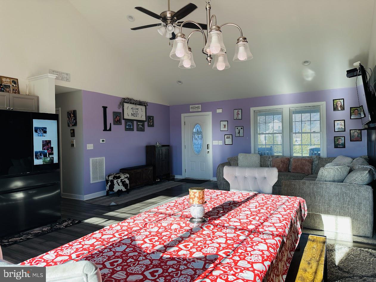 7082 Cannon Road Bridgeville, DE 19933 - Photo 14 of 67 a bedroom with a bed a chandelier and dresser