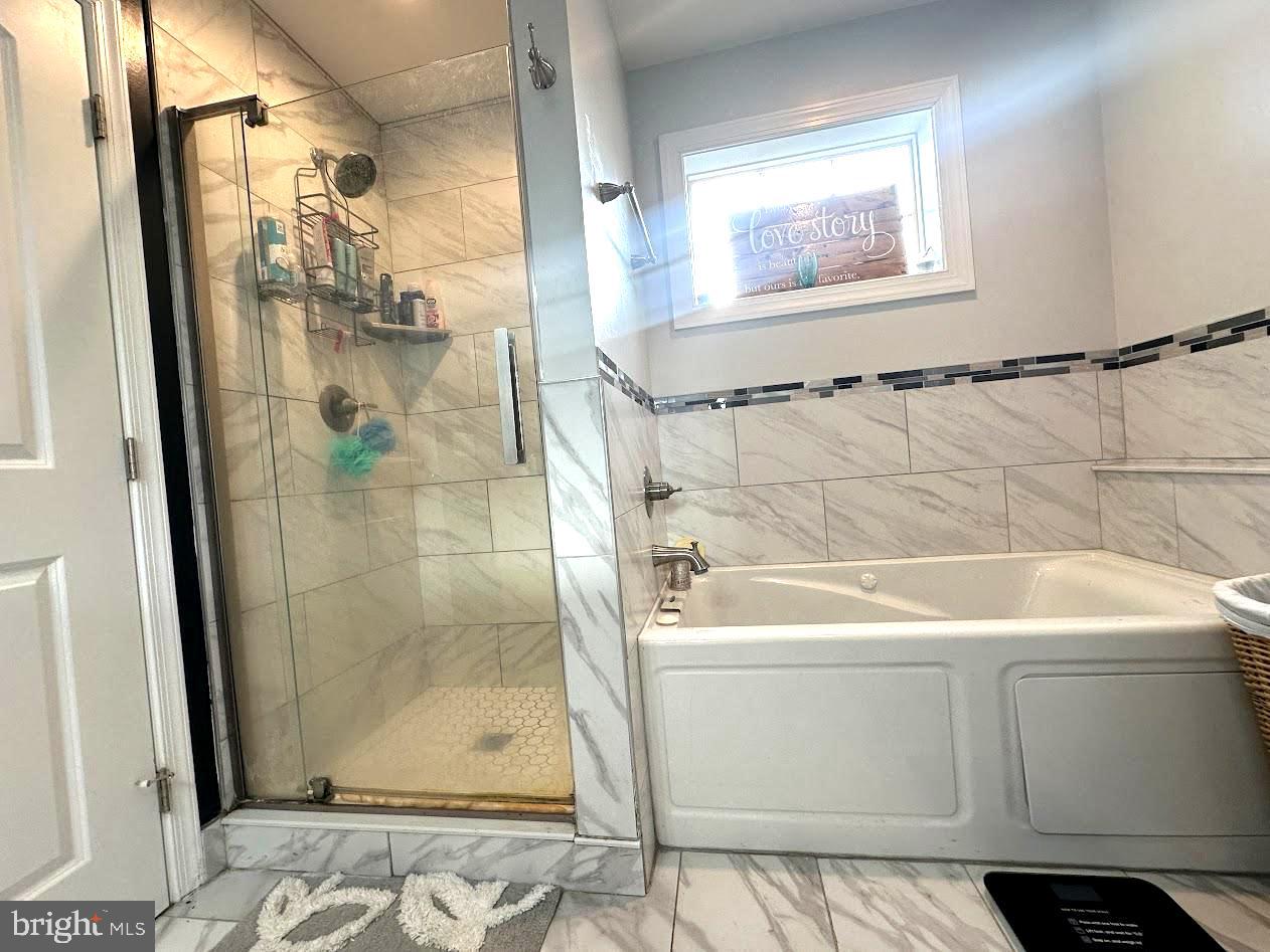 7082 Cannon Road Bridgeville, DE 19933 - Photo 26 of 67 a bathroom with a sink a window and shower