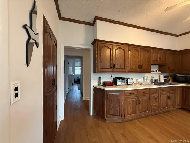 a kitchen with cabinets a sink and wooden floor