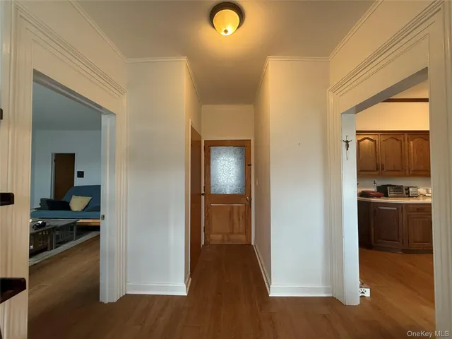 a view of a kitchen from a hallway