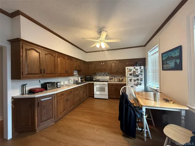 a kitchen with a sink appliances cabinets and furniture