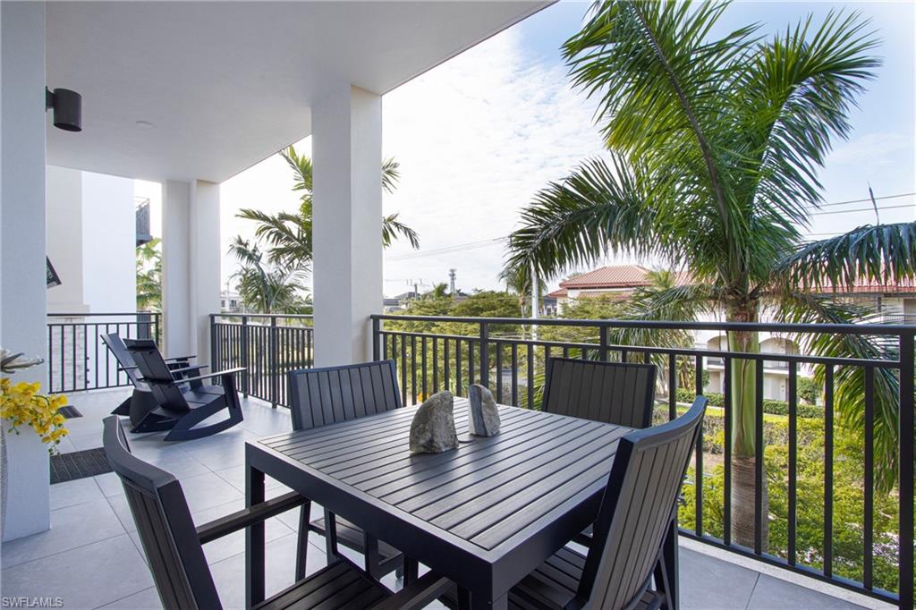 1035 3rd Avenue South, Unit 303 Naples, FL 34102 - Photo 18 of 26 a view of a balcony with a table and chairs