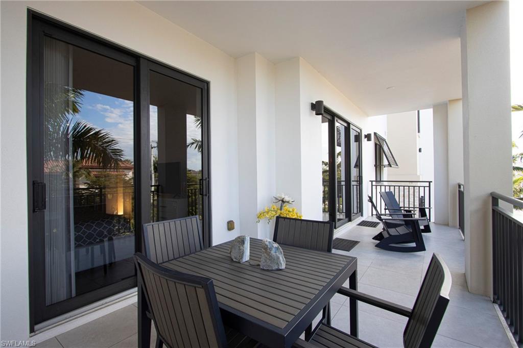 1035 3rd Avenue South, Unit 303 Naples, FL 34102 - Photo 20 of 26 a view of a dining room with furniture