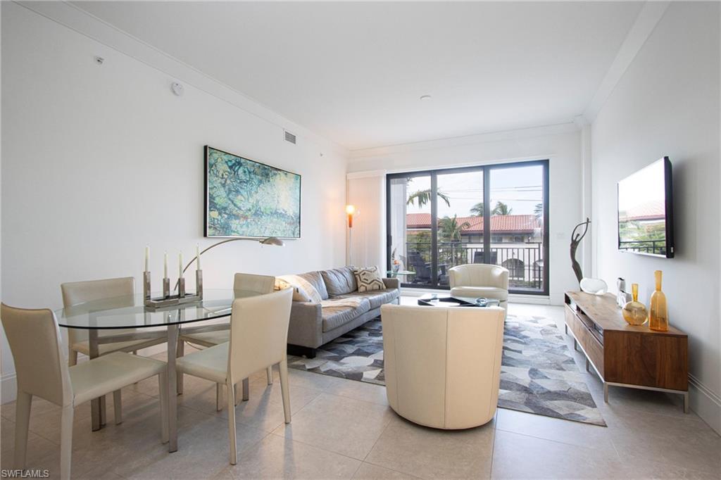 1035 3rd Avenue South, Unit 303 Naples, FL 34102 - Photo 2 of 26 a living room with furniture and a large window