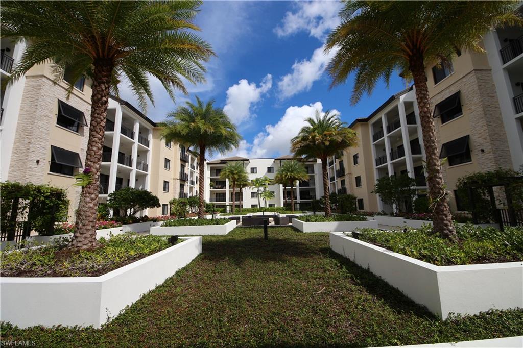1035 3rd Avenue South, Unit 303 Naples, FL 34102 - Photo 24 of 26 a view of a house with a swimming pool and a chairs