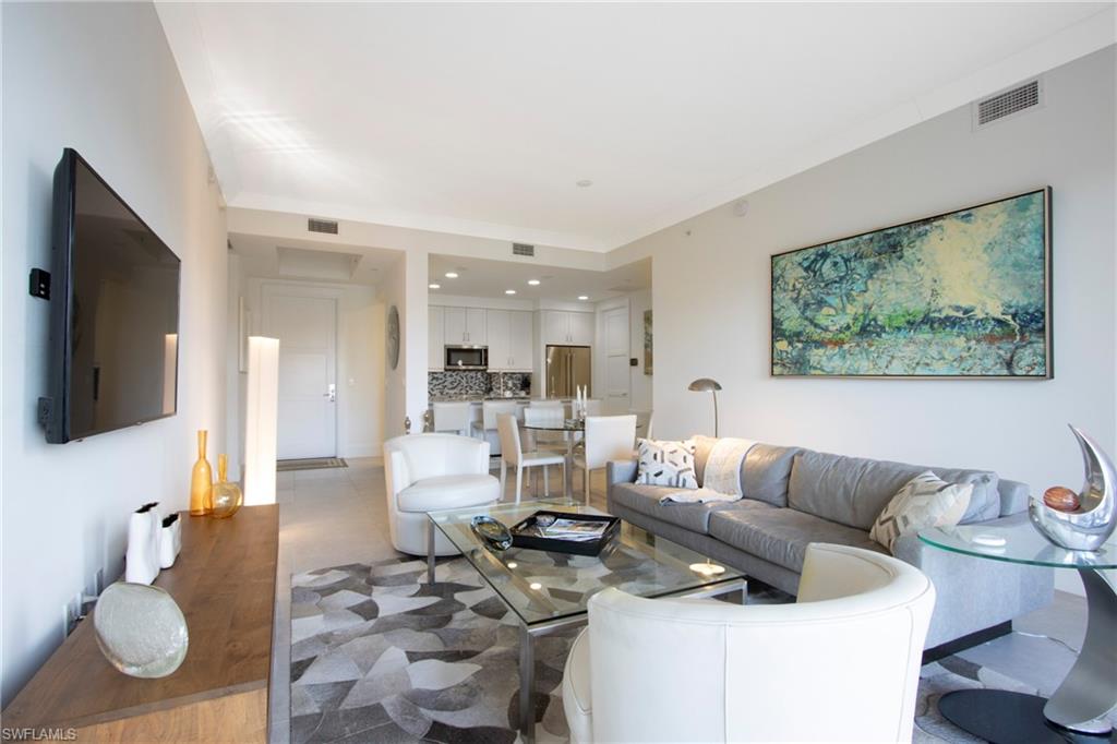 1035 3rd Avenue South, Unit 303 Naples, FL 34102 - Photo 3 of 26 a living room with furniture and a flat screen tv
