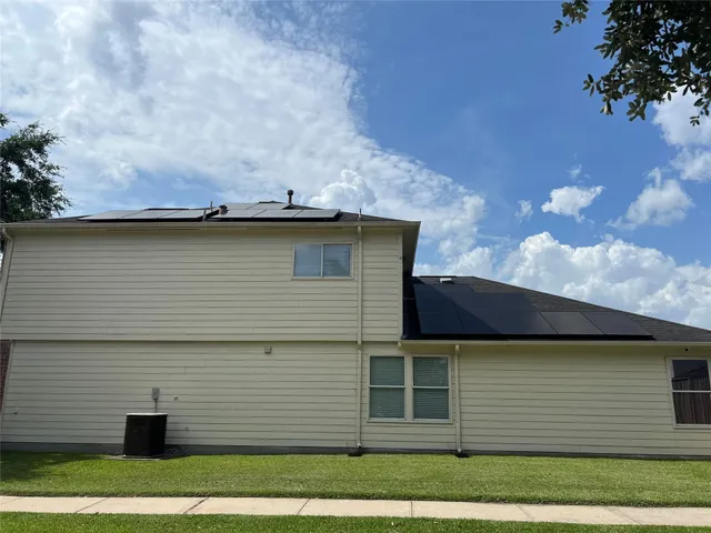 a view of a white house with a yard