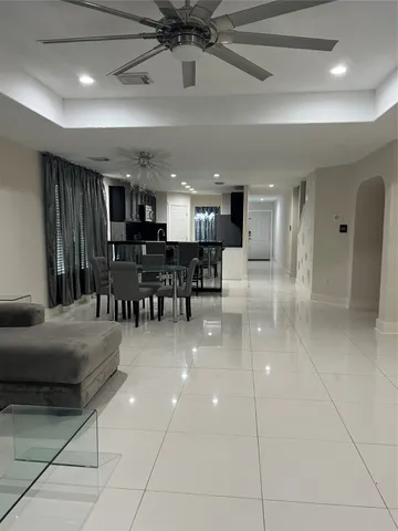 a view of a living room and kitchen with stainless steel appliances