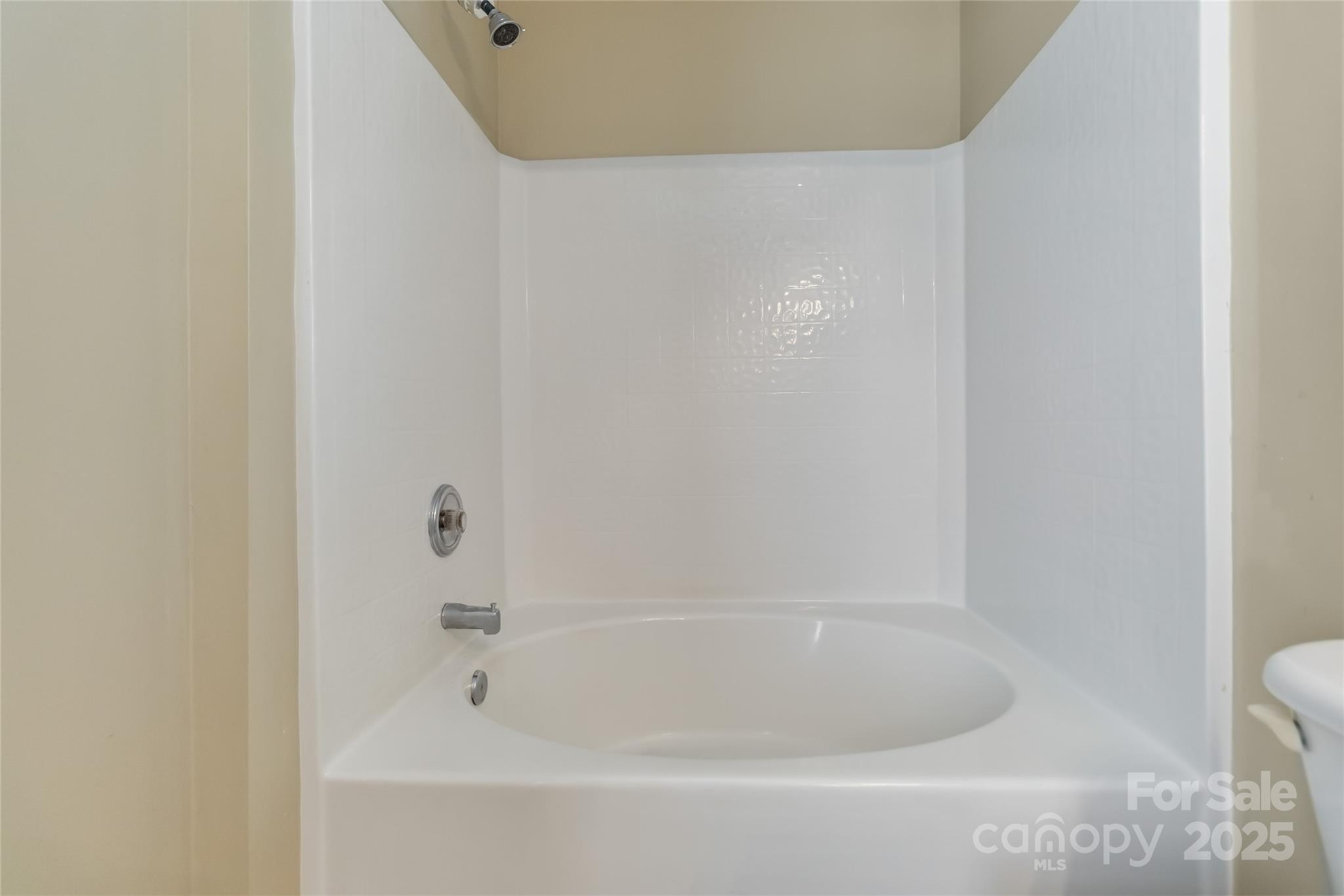 6825 Creft Circle, Unit 49 Indian Trail, NC 28079 - Photo 14 of 21 a close up of a bathtub in a bathroom