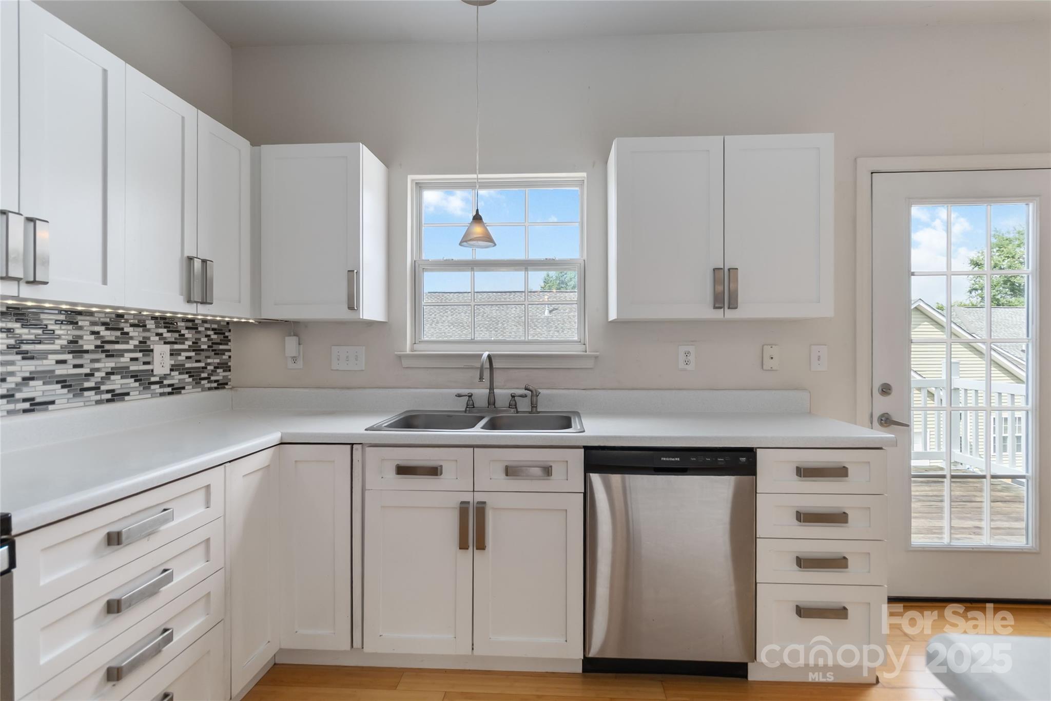 6825 Creft Circle, Unit 49 Indian Trail, NC 28079 - Photo 5 of 21 a kitchen with cabinets appliances a sink and a window