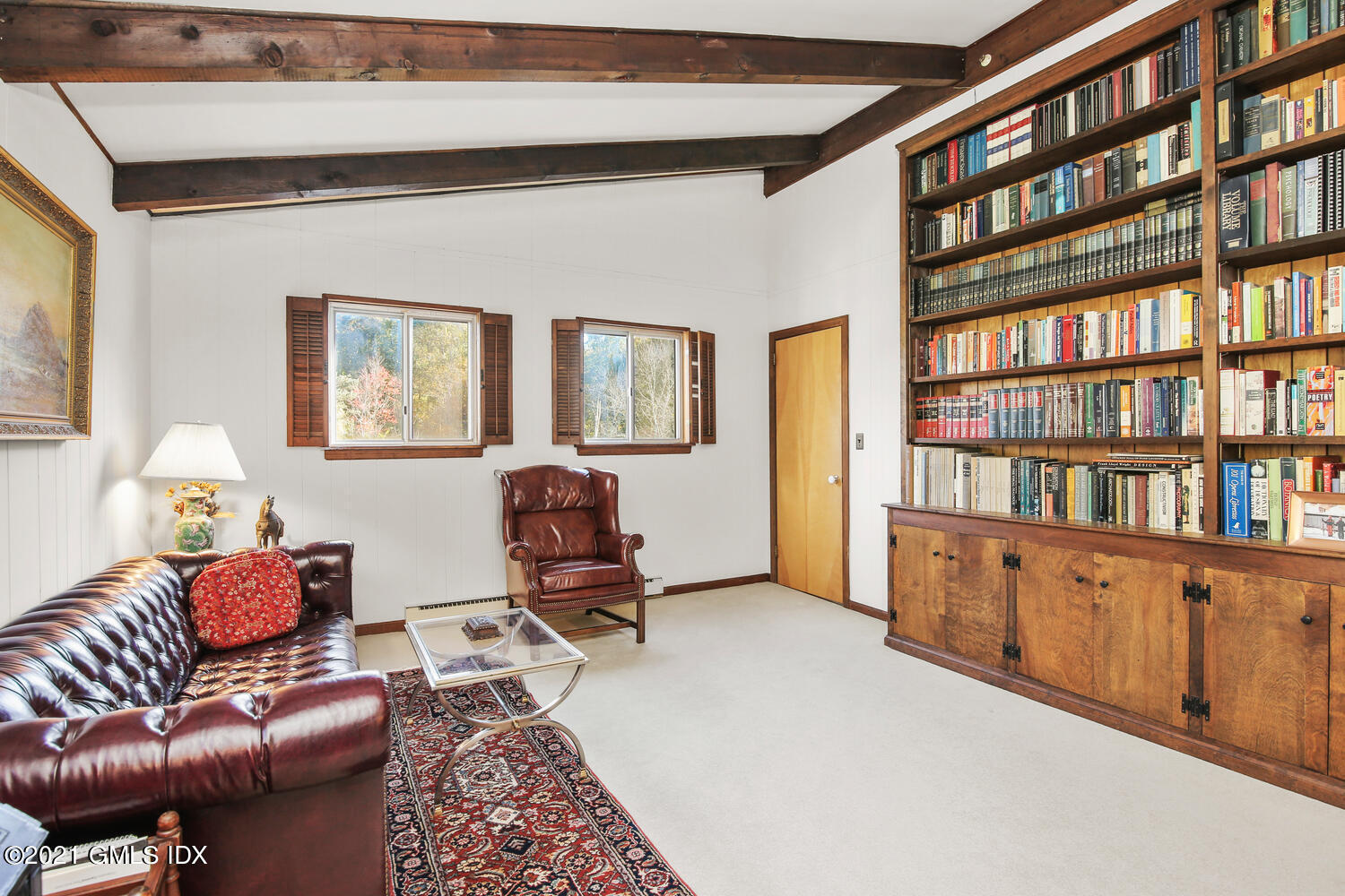 387 Stanwich Road Greenwich, CT 06830 - Photo 26 of 50 a living room with furniture and a book shelf