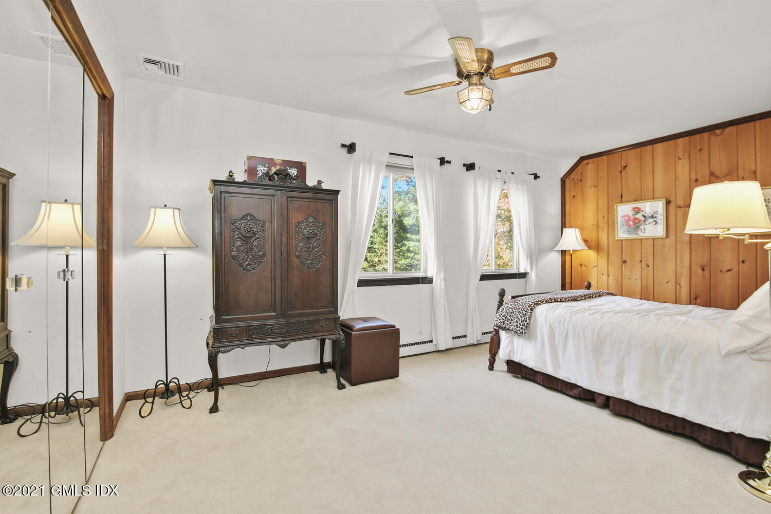 387 Stanwich Road Greenwich, CT 06830 - Photo 29 of 50 a bedroom with a bed and a chandelier