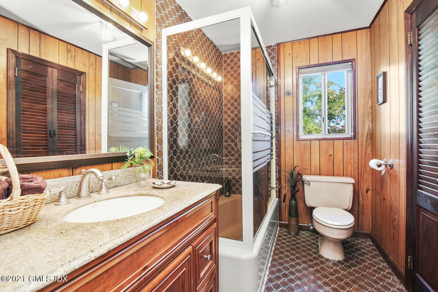387 Stanwich Road Greenwich, CT 06830 - Photo 30 of 50 a bathroom with a granite countertop sink a toilet and a large mirror