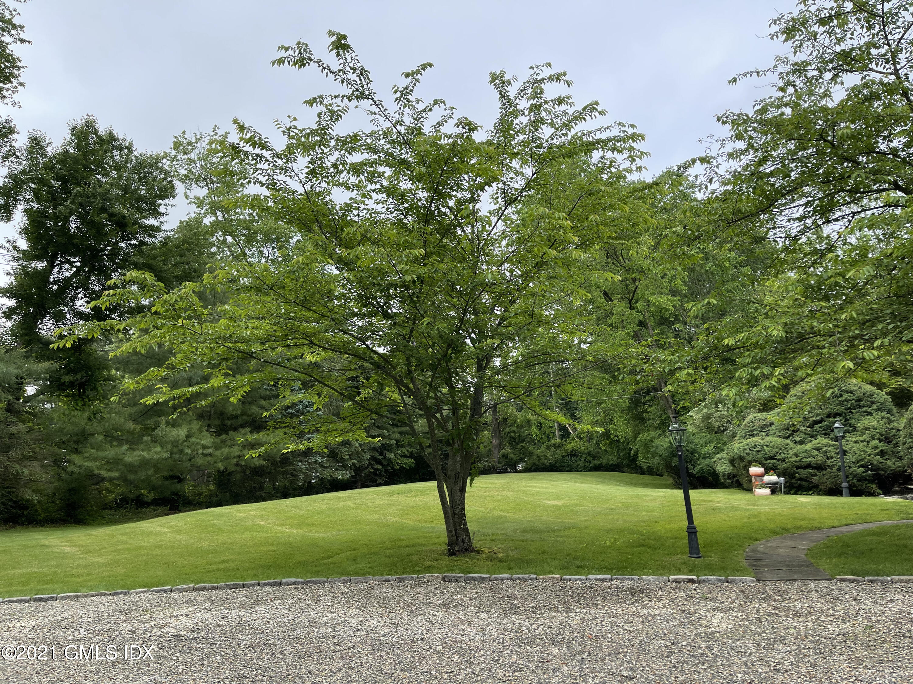 387 Stanwich Road Greenwich, CT 06830 - Photo 4 of 50 a green field with lots of trees in it