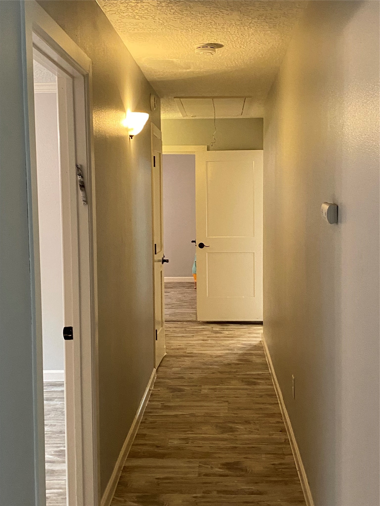 9614 Greenwillow Street Houston, TX 77096 - Photo 17 of 34 a view of a hallway with wooden floor and a bathroom