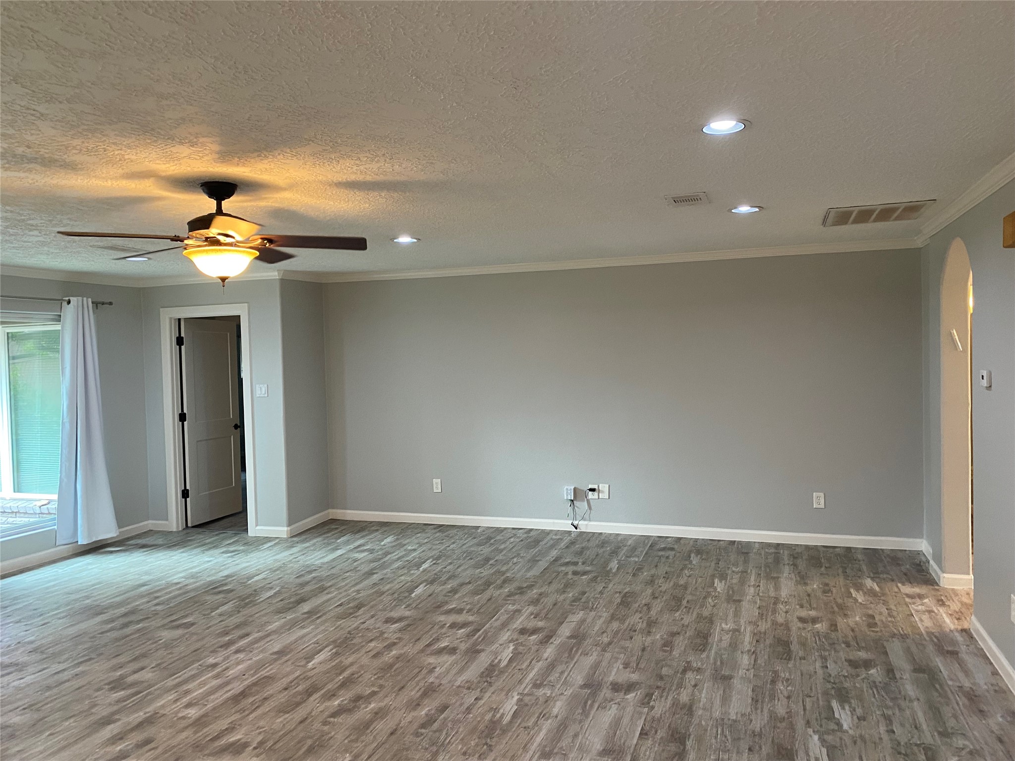 9614 Greenwillow Street Houston, TX 77096 - Photo 18 of 34 wooden floor in an empty room with a window