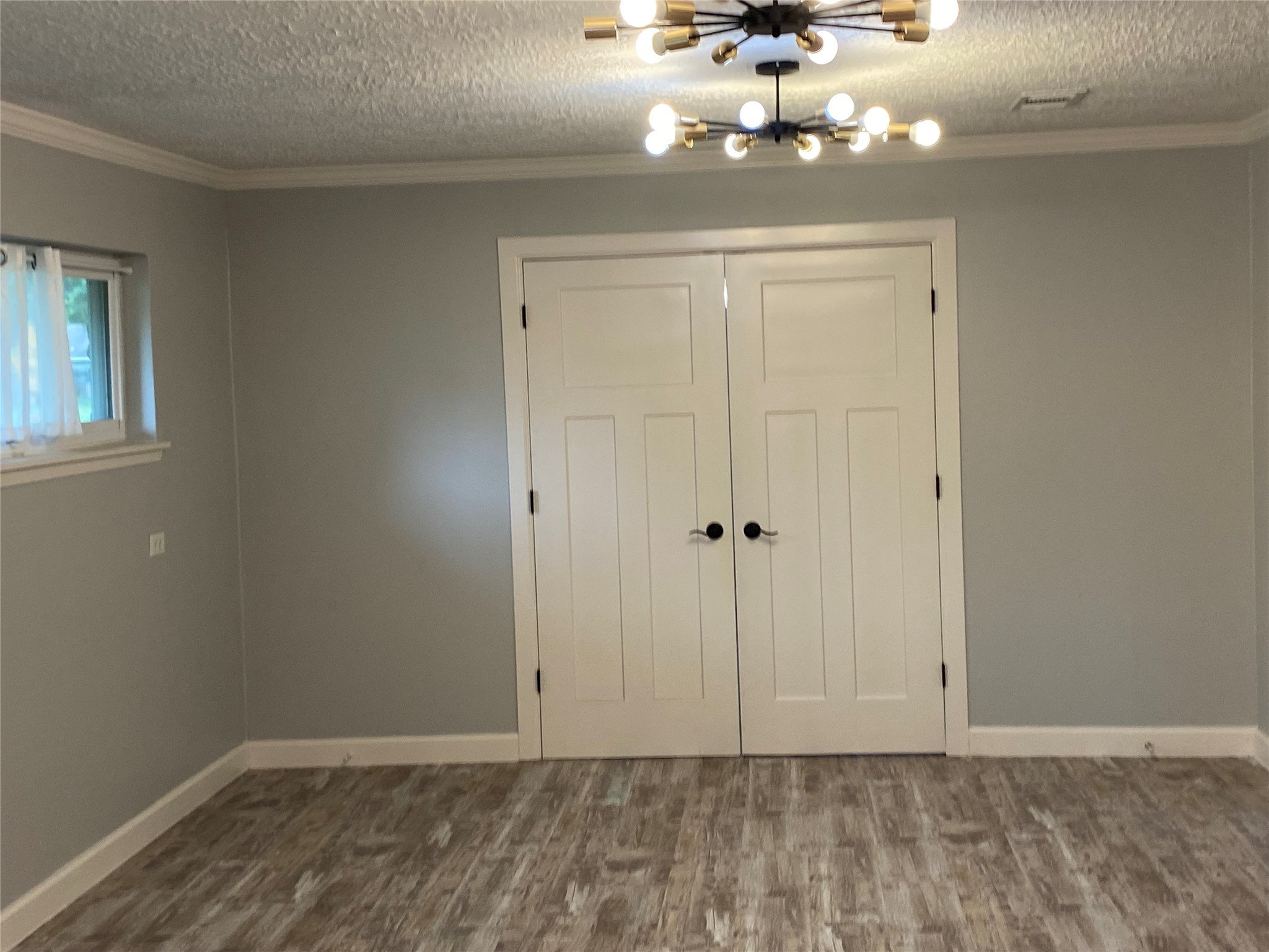 9614 Greenwillow Street Houston, TX 77096 - Photo 19 of 34 a view of a chandelier fan and hardwood floor