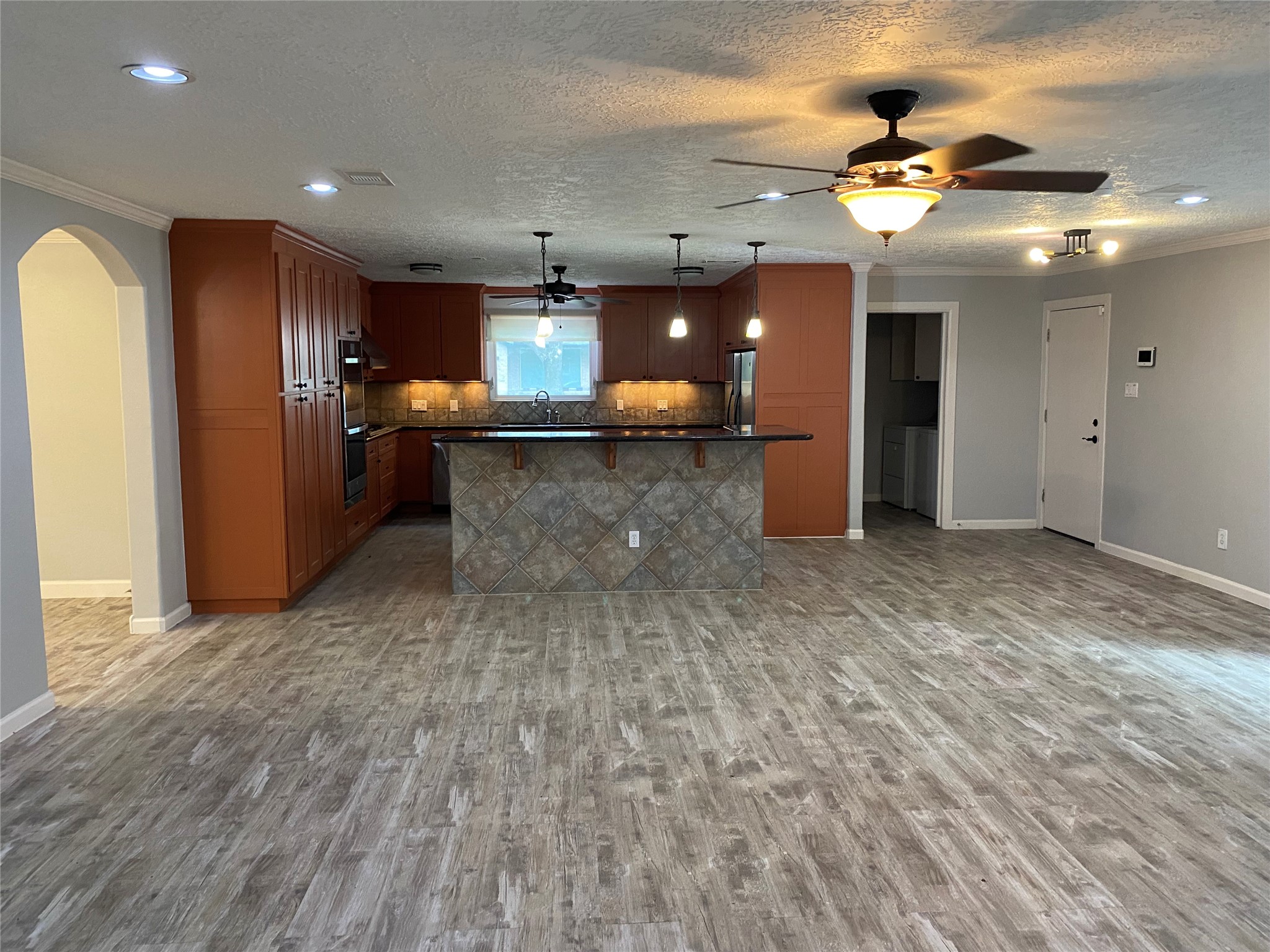9614 Greenwillow Street Houston, TX 77096 - Photo 28 of 34 a large room with lots of counter space and a chandelier