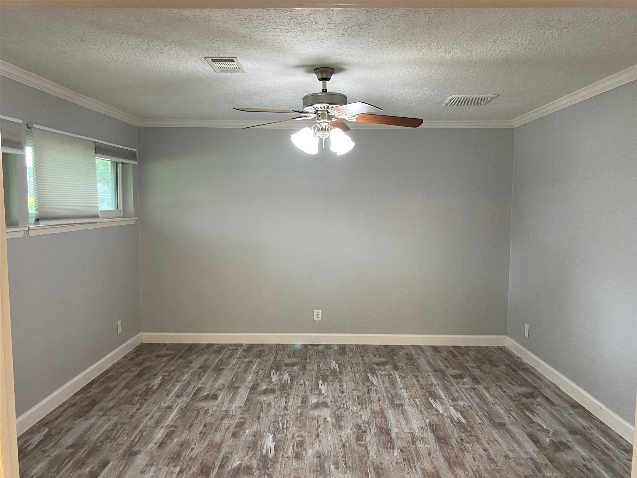 9614 Greenwillow Street Houston, TX 77096 - Photo 29 of 34 a big room with chandelier fan and windows
