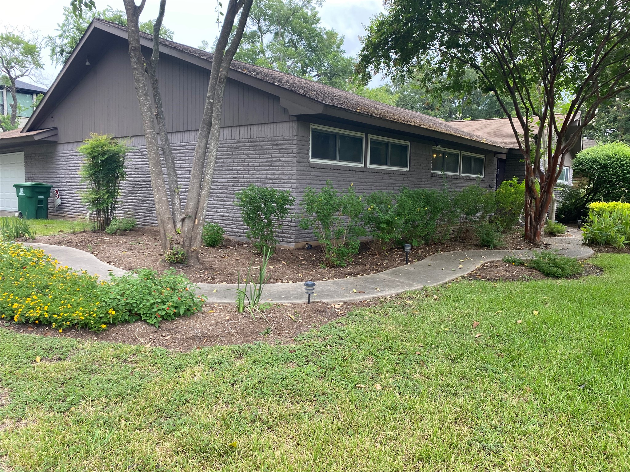 9614 Greenwillow Street Houston, TX 77096 - Photo 3 of 34 a front view of a house with a yard