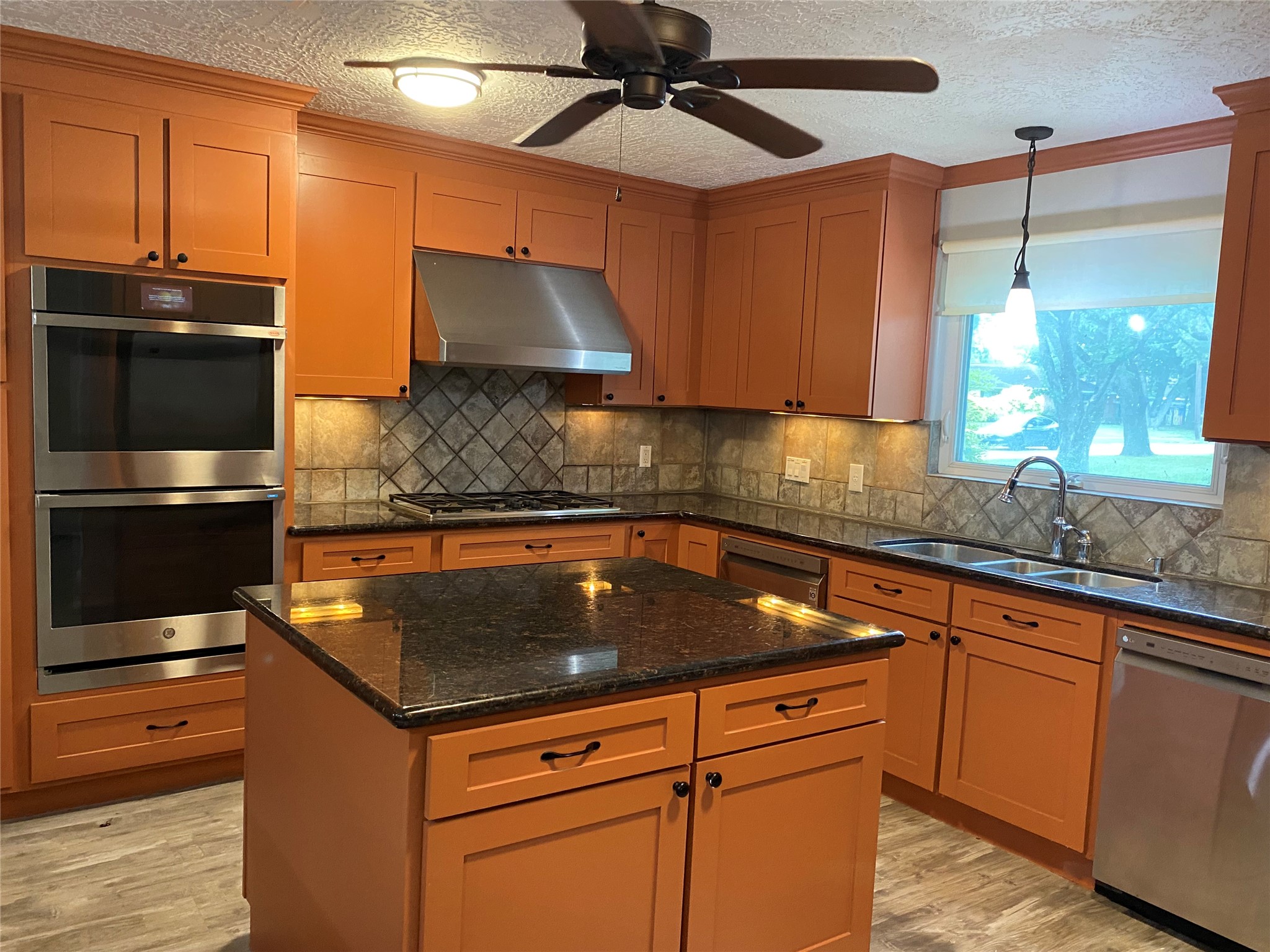 9614 Greenwillow Street Houston, TX 77096 - Photo 7 of 34 a kitchen with stainless steel appliances granite countertop a sink a stove and a microwave oven